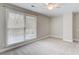 Bedroom with carpet, window, and ceiling fan at 9385 N Lake Dr, Roswell, GA 30076