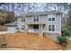 Gray siding two-story house with stone accents, a porch, and a two-car garage at 9385 N Lake Dr, Roswell, GA 30076