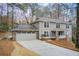 Gray two-story house with attached garage and landscaping at 9385 N Lake Dr, Roswell, GA 30076