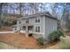 Gray sided two story home with stone accents and covered porch at 9385 N Lake Dr, Roswell, GA 30076