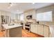 Spacious kitchen featuring granite countertops, stainless steel appliances, and hardwood floors at 9385 N Lake Dr, Roswell, GA 30076