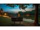 Scenic lake view at sunset with a bench under a tree at 9385 N Lake Dr, Roswell, GA 30076