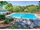 Community pool with lounge chairs and nearby clubhouse at 9385 N Lake Dr, Roswell, GA 30076