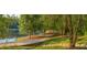 Paved lakeside walking path with lush greenery at 9385 N Lake Dr, Roswell, GA 30076