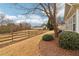 Landscaped backyard with wooden fence and trees at 1003 Somerton Pl, Cumming, GA 30040