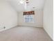 Spacious bedroom with carpeted floor, ceiling fan, and large window at 1003 Somerton Pl, Cumming, GA 30040