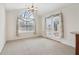 Spacious dining area with an arched window and access to backyard patio at 1003 Somerton Pl, Cumming, GA 30040