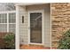 Front door entrance with stone and column accents at 1003 Somerton Pl, Cumming, GA 30040