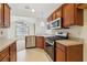 Kitchen features stainless steel appliances and wood cabinets at 1003 Somerton Pl, Cumming, GA 30040