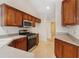 Kitchen with stainless steel appliances and wood cabinets at 1003 Somerton Pl, Cumming, GA 30040