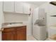 Laundry room with washer, dryer, cabinets, and shelving at 1003 Somerton Pl, Cumming, GA 30040