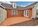 Large patio area with brick wall and wood fence at 1003 Somerton Pl, Cumming, GA 30040