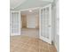 Sunroom with French doors opening to the living room and tile floors at 1003 Somerton Pl, Cumming, GA 30040