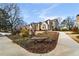 Beige townhouses with manicured landscaping and a paved pathway at 1418 Defoors Nw Dr, Atlanta, GA 30318