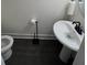 Clean powder room with pedestal sink and dark floors at 1887 Plainsboro Dr, Lithonia, GA 30058