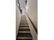 Modern staircase with dark wood steps and railing at 1887 Plainsboro Dr, Lithonia, GA 30058