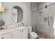 Modern bathroom with walk-in shower and oval mirror at 230 Central Ave, Fayetteville, GA 30214