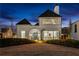 Stunning white brick home featuring a dramatic arched entryway, elegant lines, and lush, gently sloping landscaping at 230 Central Ave, Fayetteville, GA 30214