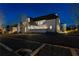 Night view of a stunning luxury home with beautiful landscaping at 230 Central Ave, Fayetteville, GA 30214