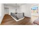 Light-filled hallway with hardwood floors and chandelier at 230 Central Ave, Fayetteville, GA 30214