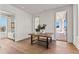 Light-filled hallway with wood floors and access to bedrooms and balcony at 230 Central Ave, Fayetteville, GA 30214