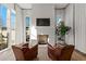 Bright living room with fireplace and leather armchairs at 230 Central Ave, Fayetteville, GA 30214