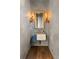 Chic powder room with floating sink, ornate mirror, and sconces at 230 Central Ave, Fayetteville, GA 30214