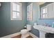 Stylish bathroom with pedestal sink and light blue walls at 393 Summerhour St, Marietta, GA 30060