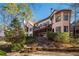 Stone patio with seating area and view of home's back elevation at 5041 Towne Lake N Hls, Woodstock, GA 30189