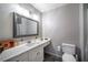 Bathroom with a white vanity, quartz countertop, and large mirror at 5041 Towne Lake N Hls, Woodstock, GA 30189