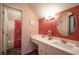 Well-lit bathroom with white vanity and large mirror at 5041 Towne Lake N Hls, Woodstock, GA 30189