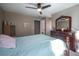 Bright bedroom with ceiling fan, dresser, and comfortable bed at 5041 Towne Lake N Hls, Woodstock, GA 30189