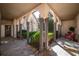 Inviting courtyard with arched entryways, lush greenery, and flagstone flooring at 5041 Towne Lake N Hls, Woodstock, GA 30189