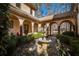 Charming courtyard featuring a central fountain and meticulously landscaped greenery at 5041 Towne Lake N Hls, Woodstock, GA 30189