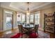 Sunlit dining area with table and chairs near back door access at 5041 Towne Lake N Hls, Woodstock, GA 30189