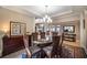 Elegant dining room featuring a glass-top table, rich wood chairs, and an ornate rug at 5041 Towne Lake N Hls, Woodstock, GA 30189