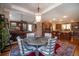 Elegant dining area with wood table and chairs, open to kitchen at 5041 Towne Lake N Hls, Woodstock, GA 30189