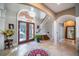 Two-story foyer with tile flooring, chandelier, and curved staircase at 5041 Towne Lake N Hls, Woodstock, GA 30189