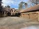 Elegant home features a three-car garage, basketball hoop, and a spacious driveway at 5041 Towne Lake N Hls, Woodstock, GA 30189