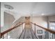 Upstairs hallway with wood railings and carpeted floor at 5041 Towne Lake N Hls, Woodstock, GA 30189