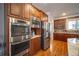 Modern kitchen with stainless steel appliances and wood cabinets at 5041 Towne Lake N Hls, Woodstock, GA 30189