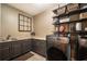 Laundry room with dark cabinets, granite countertop, and a utility sink at 5041 Towne Lake N Hls, Woodstock, GA 30189