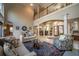 Two-story living room with a fireplace and lots of natural light at 5041 Towne Lake N Hls, Woodstock, GA 30189