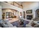 Two-story living room with a fireplace and lots of natural light at 5041 Towne Lake N Hls, Woodstock, GA 30189