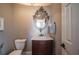 Elegant powder room with a decorative mirror and marble vanity at 5041 Towne Lake N Hls, Woodstock, GA 30189