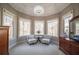 Peaceful sitting area with bay windows, two armchairs, and a lovely floral arrangement at 5041 Towne Lake N Hls, Woodstock, GA 30189