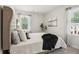 Main bedroom with tufted headboard and large window at 553 Cygnet Ln, Grayson, GA 30017