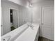 Double vanity bathroom with a large mirror and access to another room at 1206 Persimmon Way, Mcdonough, GA 30252