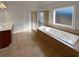 Bathroom with a garden tub, double vanity, and tiled floors at 1206 Persimmon Way, Mcdonough, GA 30252