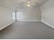 Spacious bedroom with carpeted floors and a large window at 1206 Persimmon Way, Mcdonough, GA 30252